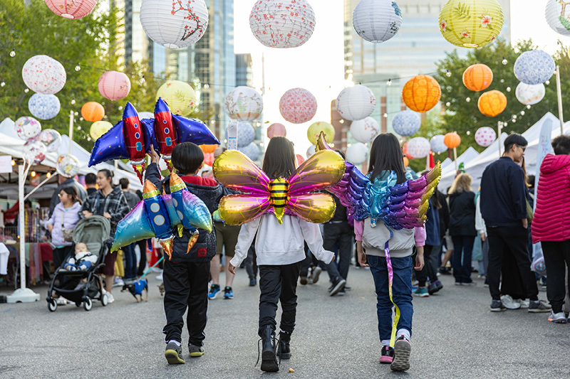Kids in costumes walking around an event