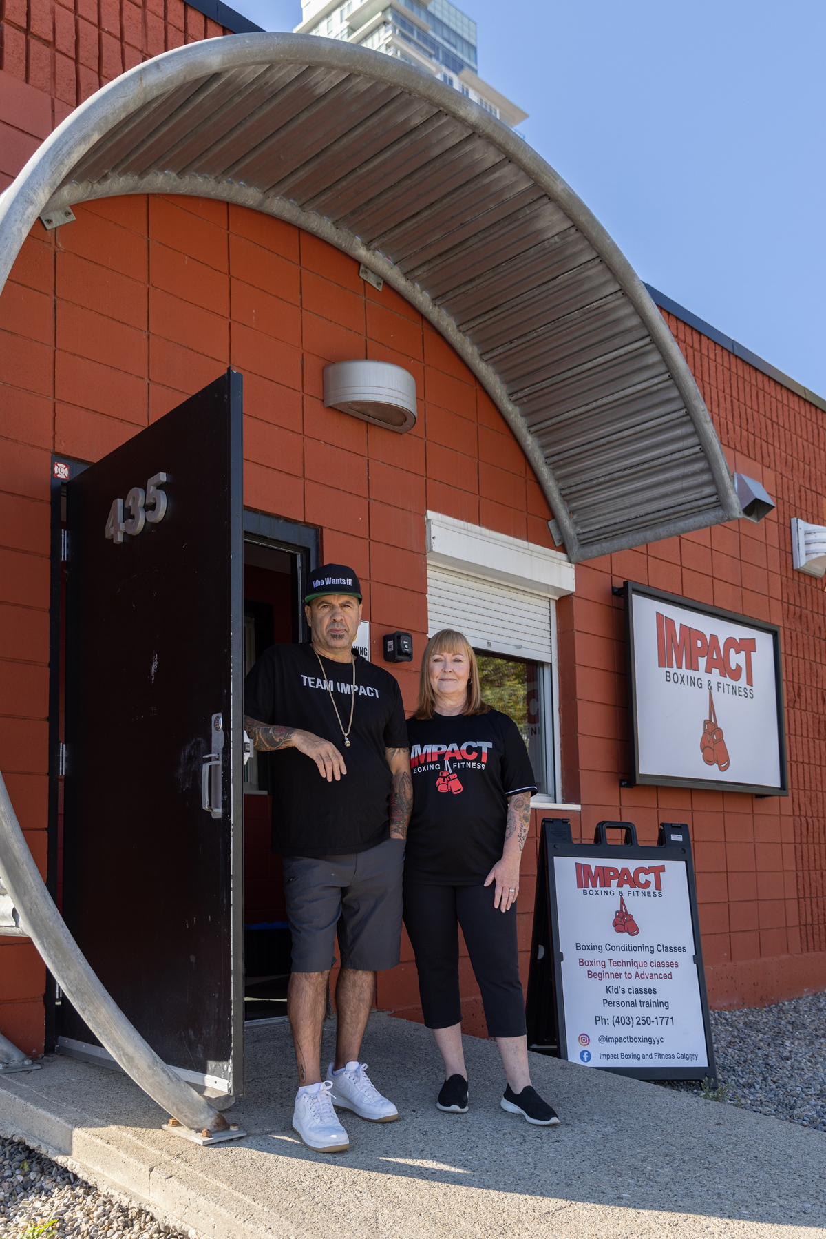 Employees at the entrance of Impact Boxing and Fitness.