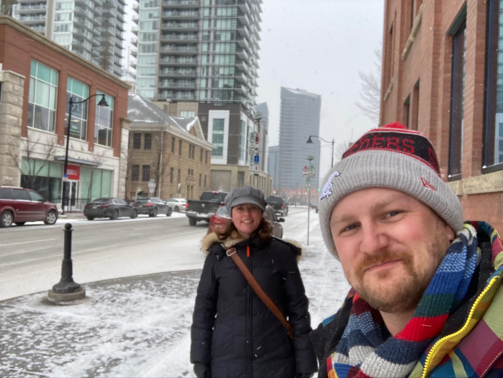 Juliet Pitts and Adam Noble-Johnson visiting businesses in the Beltline, with snow on the ground.