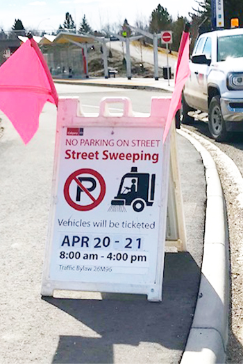Street sweeping no parking sign